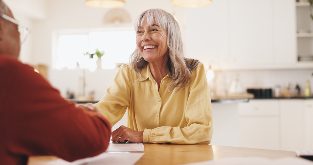 Smiling retired lady reviewing financial documents